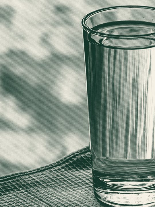A glass of clear drinking water, advertising a free in-home water test by Jones Air & Water