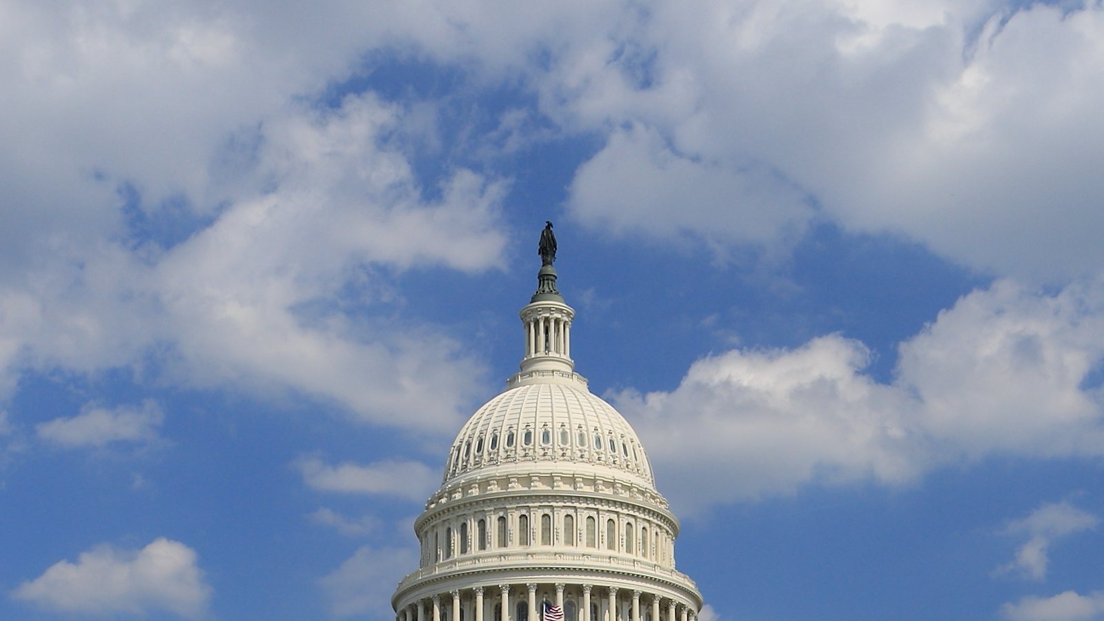 The dome of the United States Capitol with flag flying